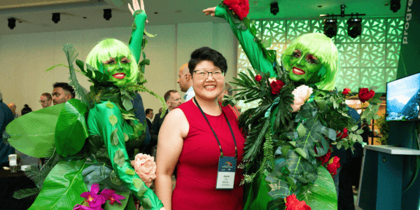 An attendee poses with entertainers at the PIC reception.